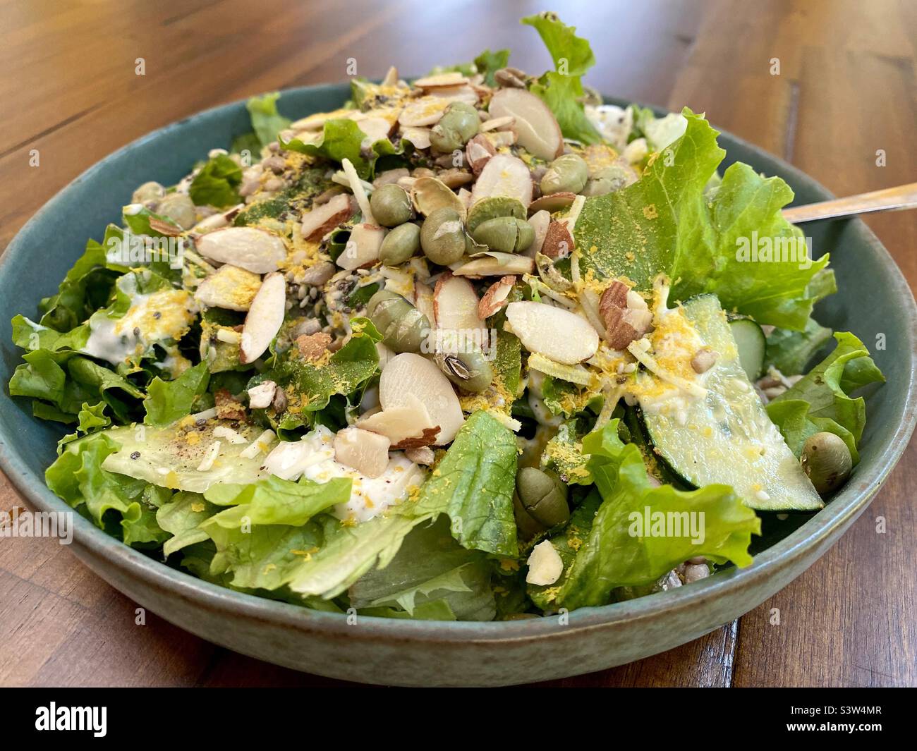 A salad with nuts, seeds, and dried edamame on top. Stock Photo