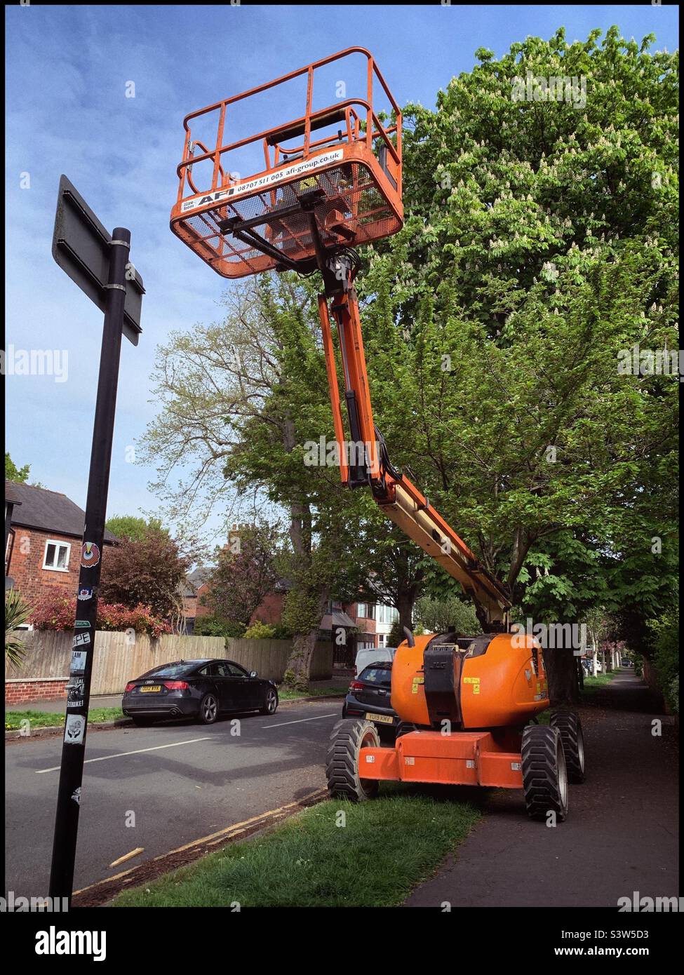 An orange cherry picker Stock Photo Alamy