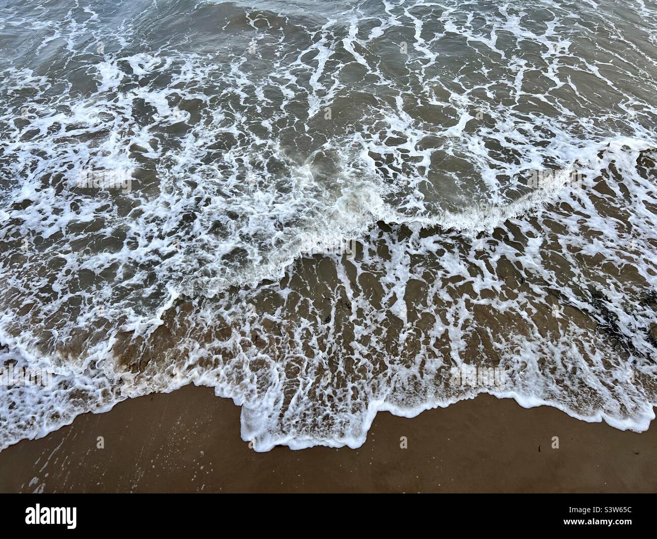 Wave finally reaches the seashore Stock Photo