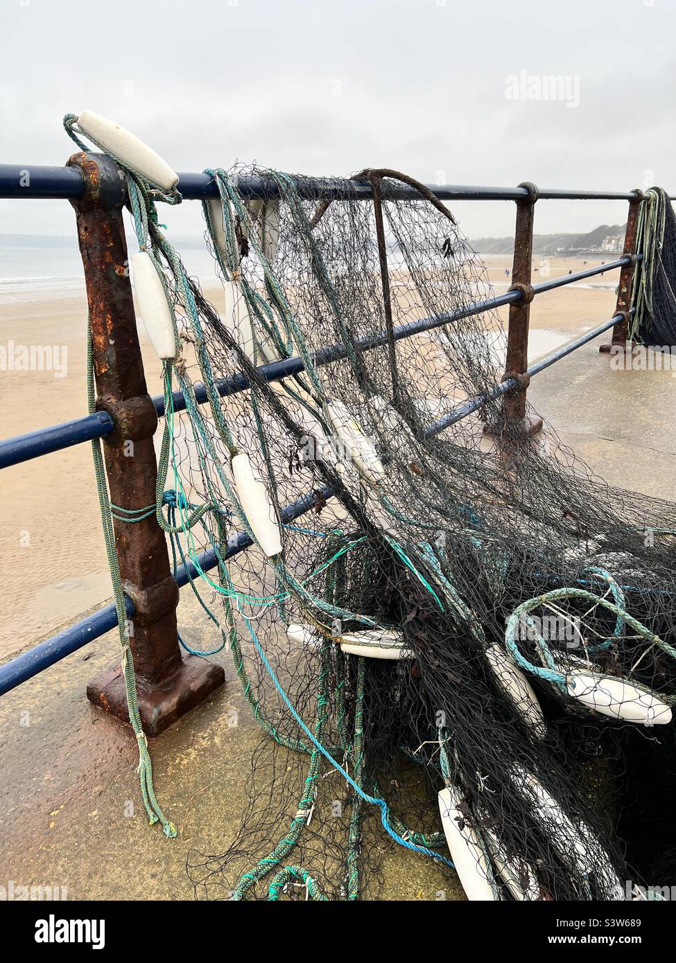 Fishing nets drying over metal railings Stock Photo Alamy