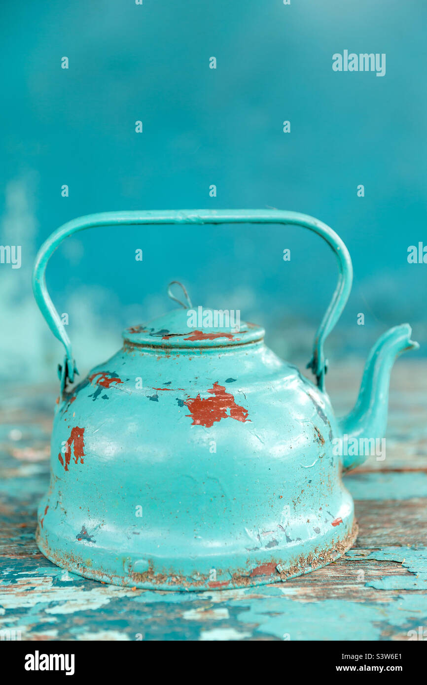 Old rustic turquoise tea kettle, object Stock Photo
