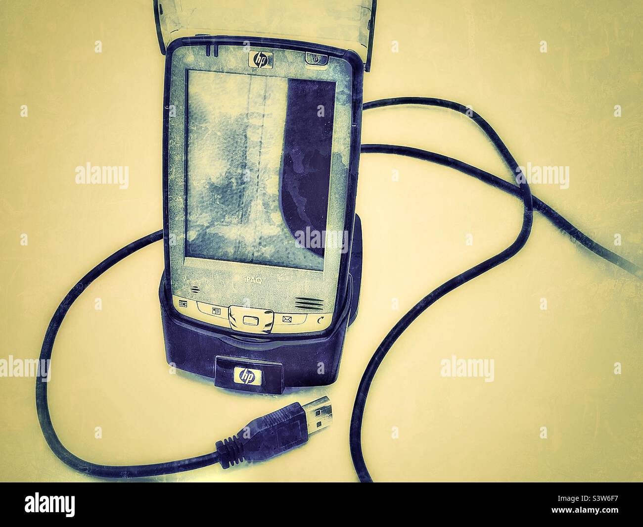 My old, outdated Hewlett-Packard PDA (Personal Digital Assistant) that I replaced with an iPhone. The grunge and aged effects digitally added are representative of this obsolete and outdated tech. - Smartphone Captured Stock Image