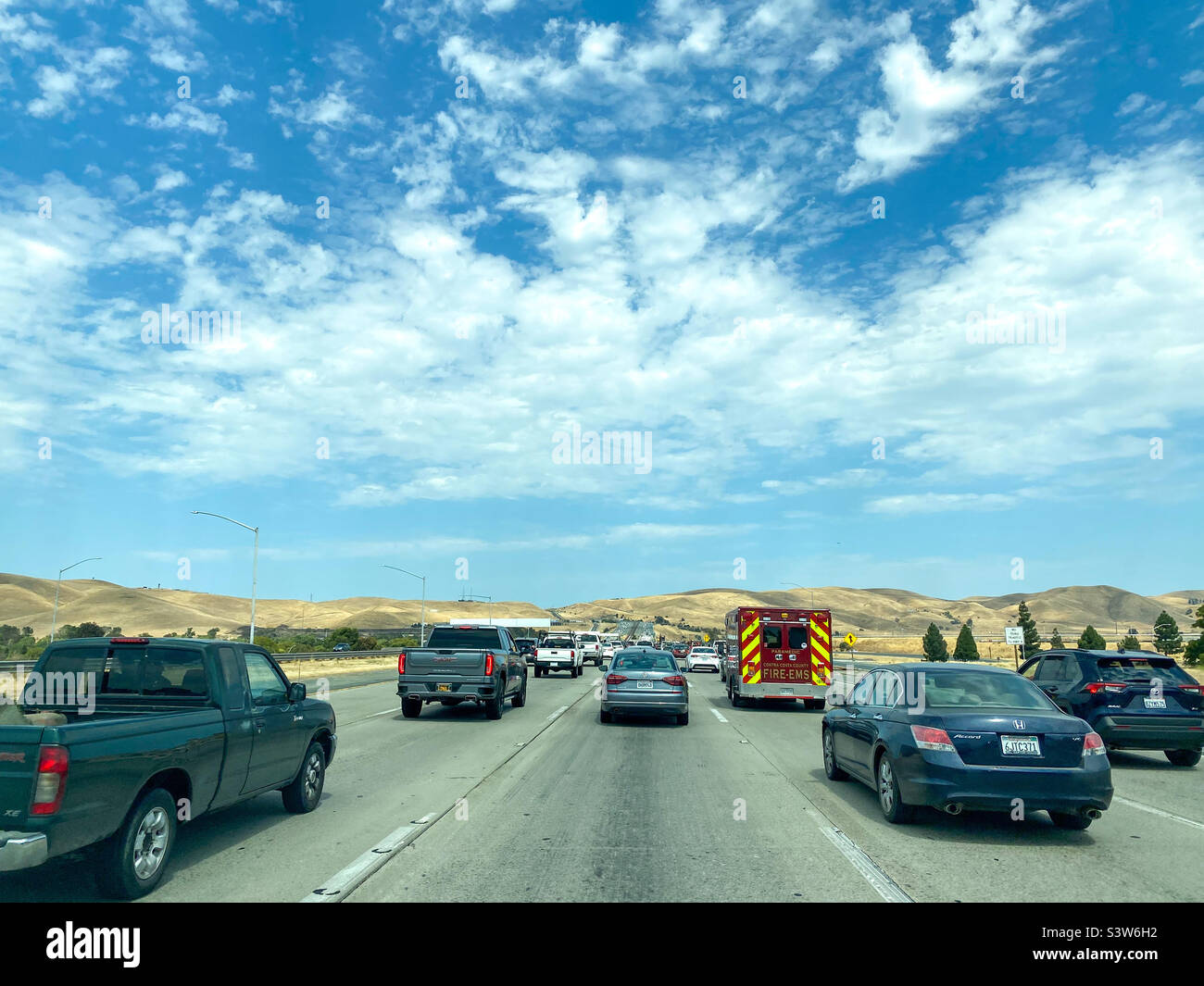 Travelling along highway 4 in California, USA busy with cars under a blue sky. - Smartphone Captured Stock Image