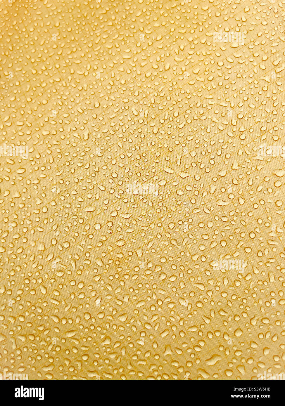 Raindrops on yellow tent canvas - Smartphone Captured Stock Image Raindrops on yellow tent canvas - Smartphone Captured Stock Image