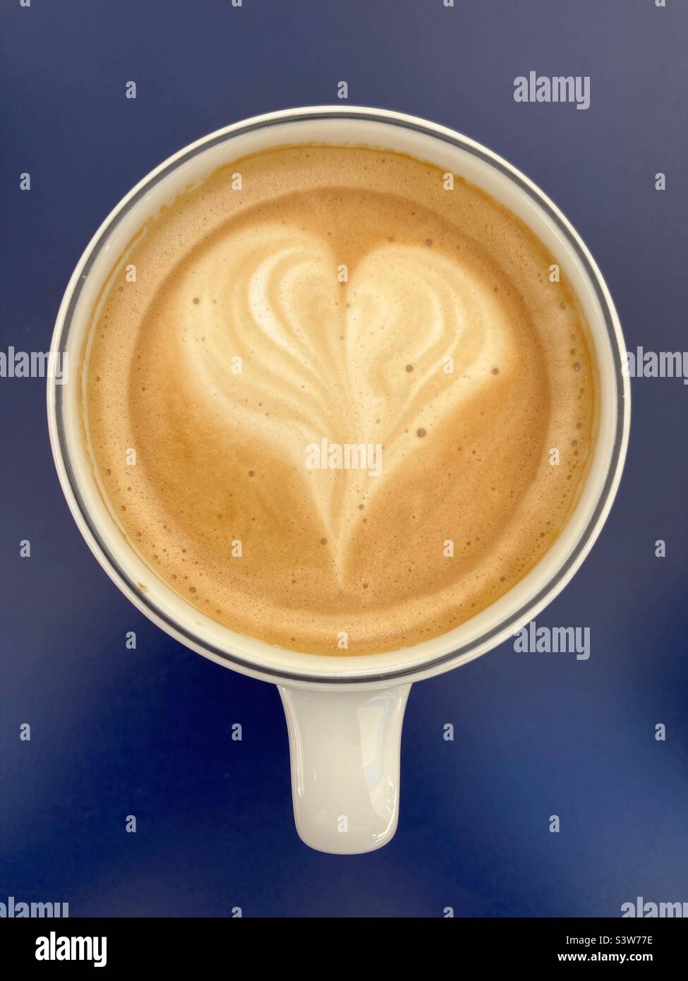 Cappuccino in a cup with a Heart in the milk froth Stock Photo