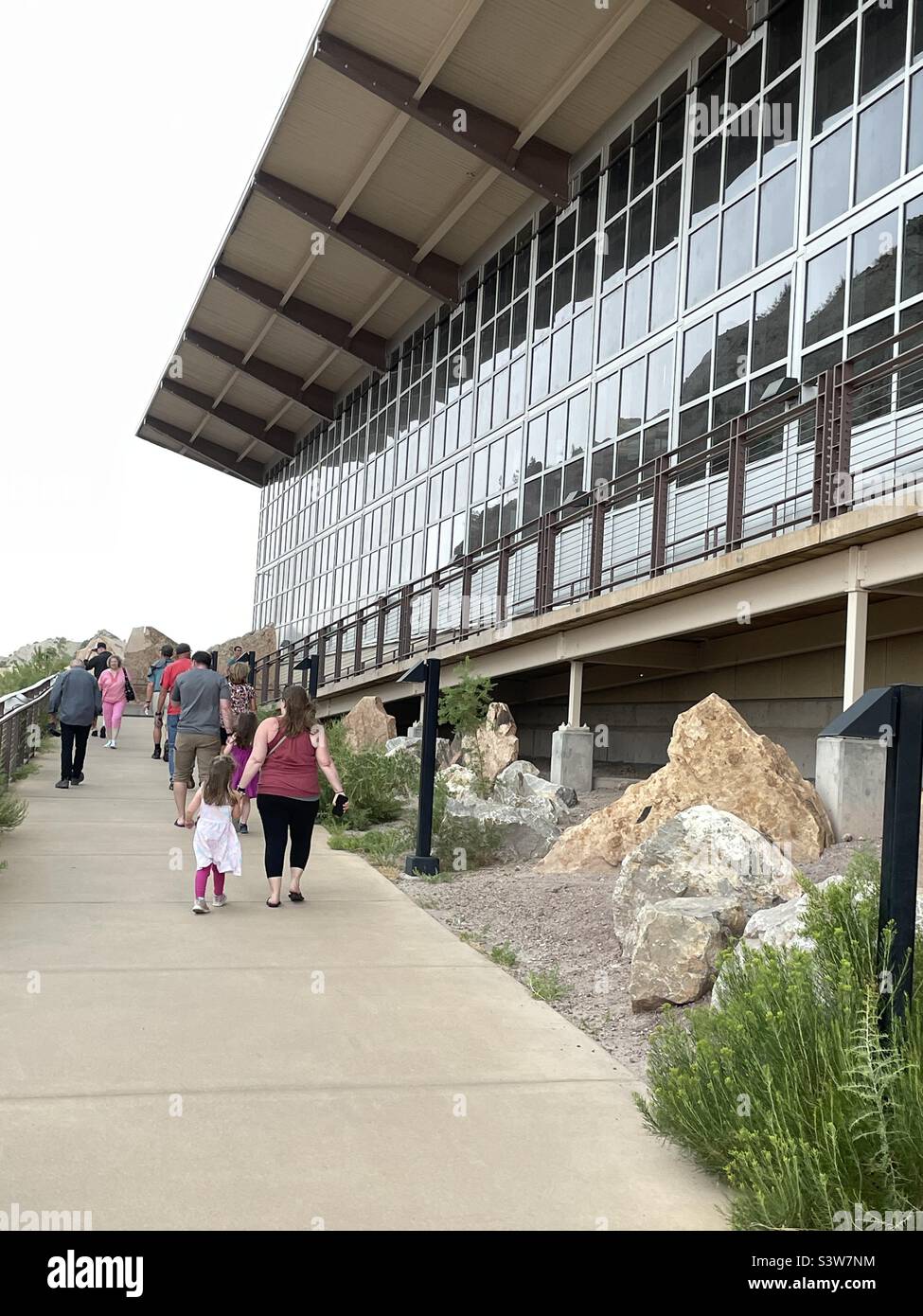 Tourists entering the National Park Service managed Dinosaur Bone and Fossil Quarry, located in Vernal, Utah, USA, the main attraction here at the Dinosaur National Monument. - Smartphone Captured Stock Image