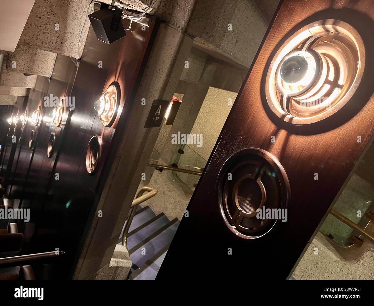 Each row of the Barbican Theatre is accessed by a side door making the theatre aisle free. As the lights dim the doors close in unison - Smartphone Captured Stock Image