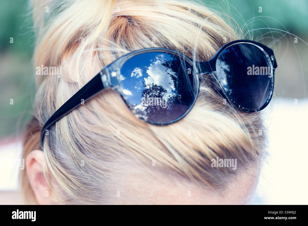 Sunglasses on a woman’s head, summer time travel - Smartphone Captured Stock Image