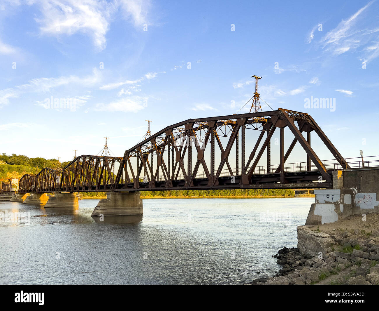 DUBUQUE, IOWA, July 30, 2022–train bridge over Mississippi River at sunset. Stock Photo