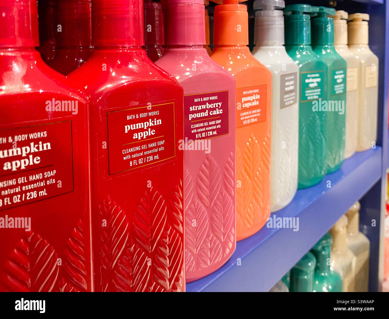Scented hand gel soaps in colourful bottles on sale at a Bath and Body Works store. - Smartphone Captured Stock Image