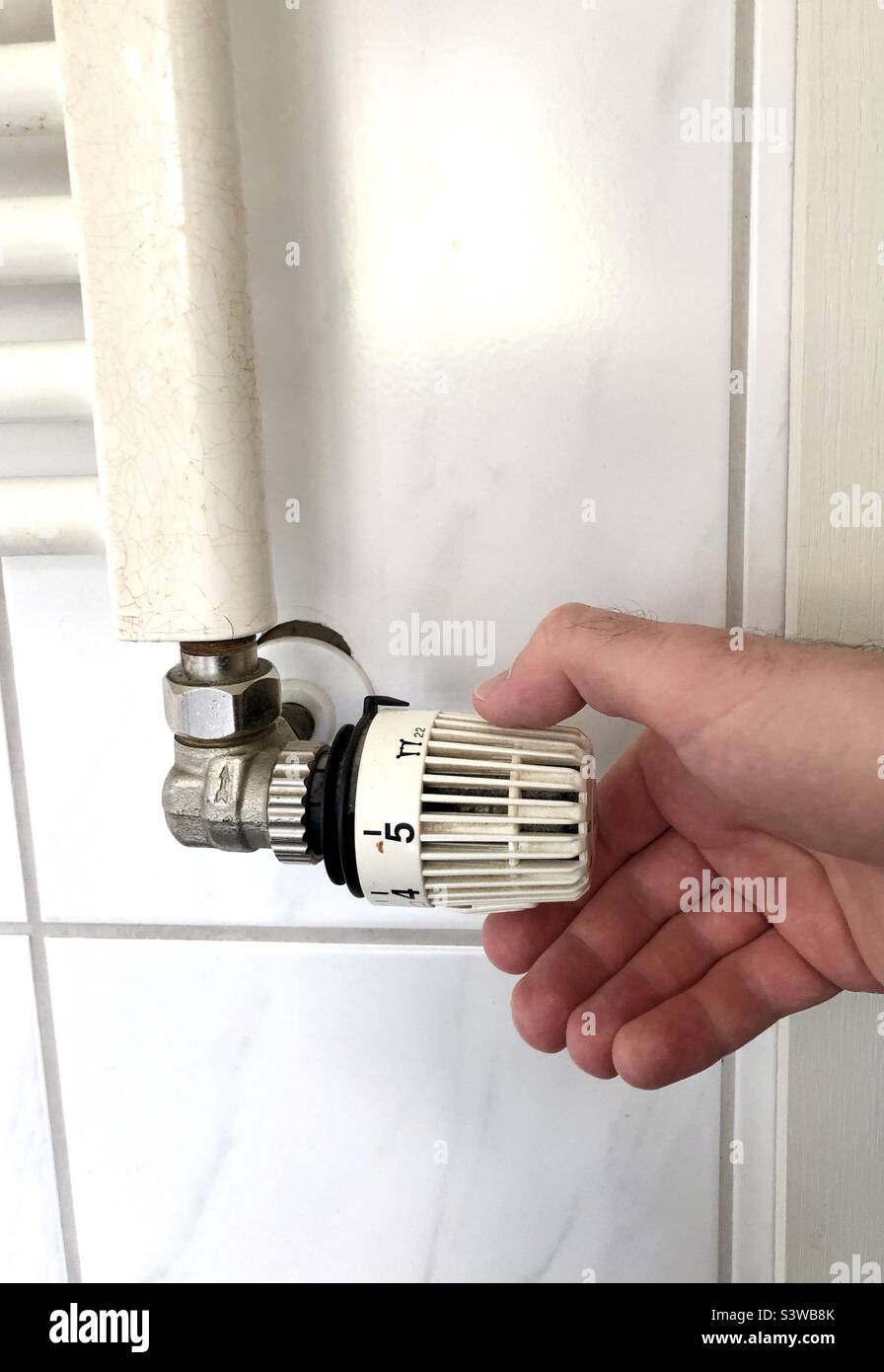 Turning down the heating Stock Photo Alamy