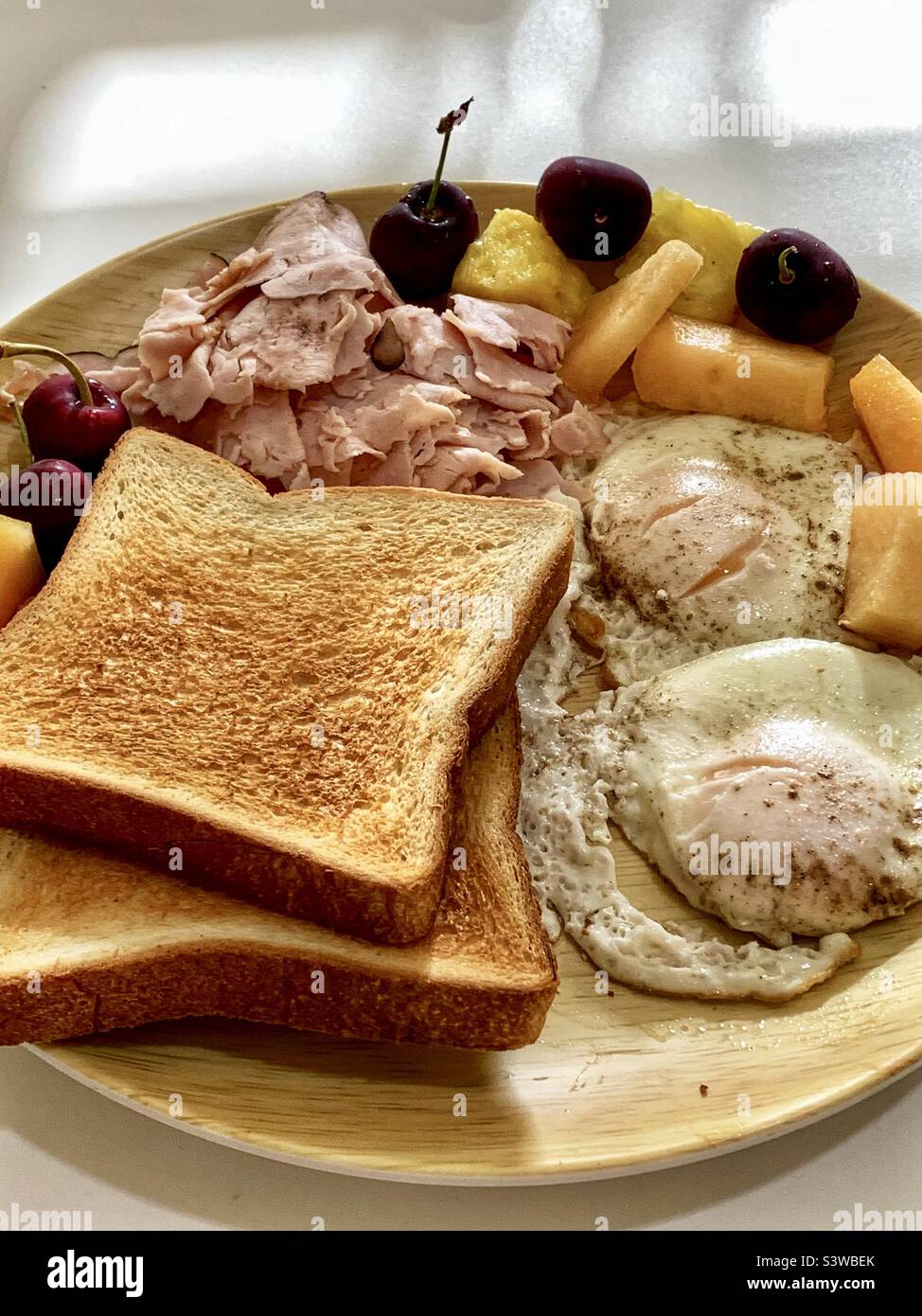 The homemade breakfast dish included toasted breads, eggs, hams, and