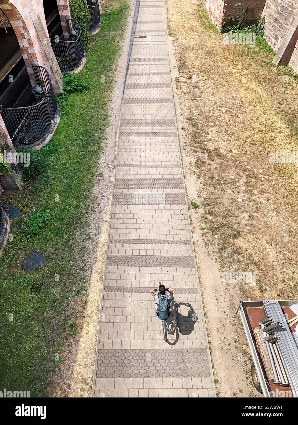 Overheard view of a young man riding a bicycle - Smartphone Captured Stock Image