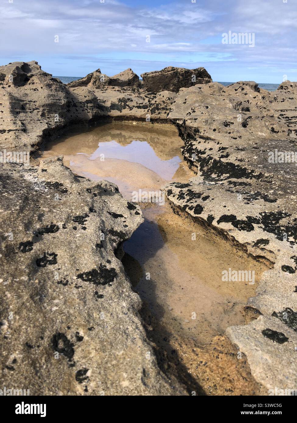 Rocks reflected in a pool of water. Stock Photo