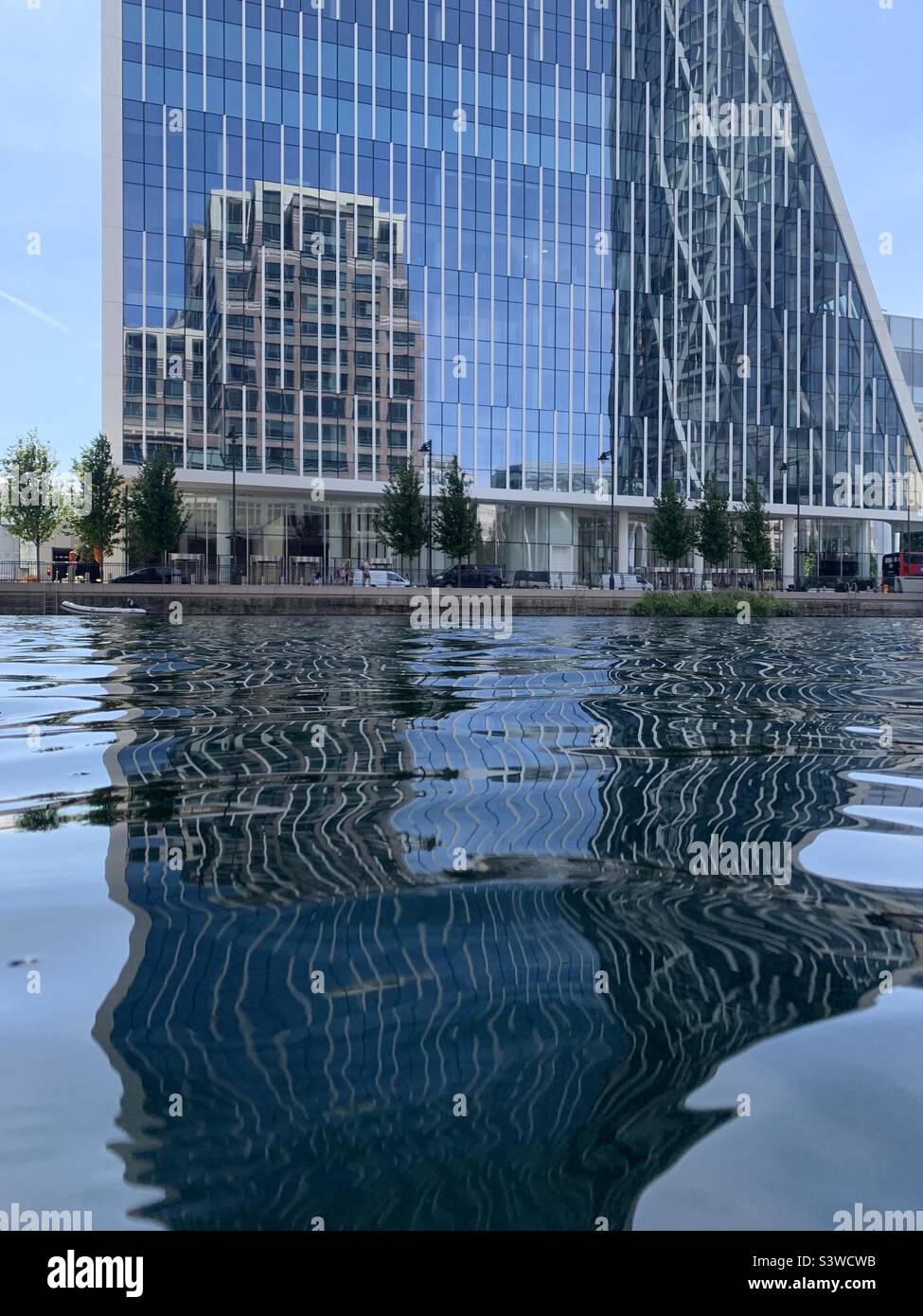Reflection of building in building and water at Canary Wharf London docklands Stock Photo