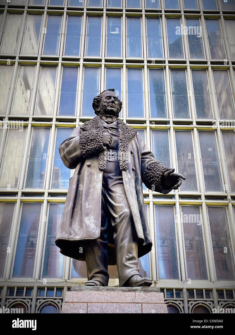 The statue of Commodore Cornelius Vanderbilt in front of a large window at the split of the Park Avenue viaduct, NYC, USA - Smartphone Captured Stock Image