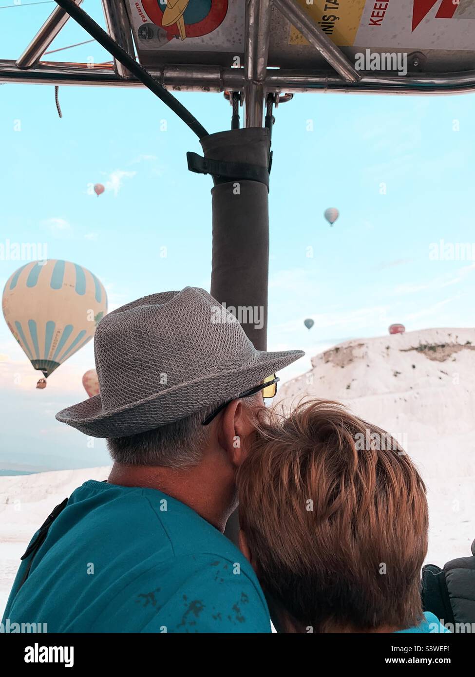Senior couple traveling together by hot air balloon - Smartphone Captured Stock Image