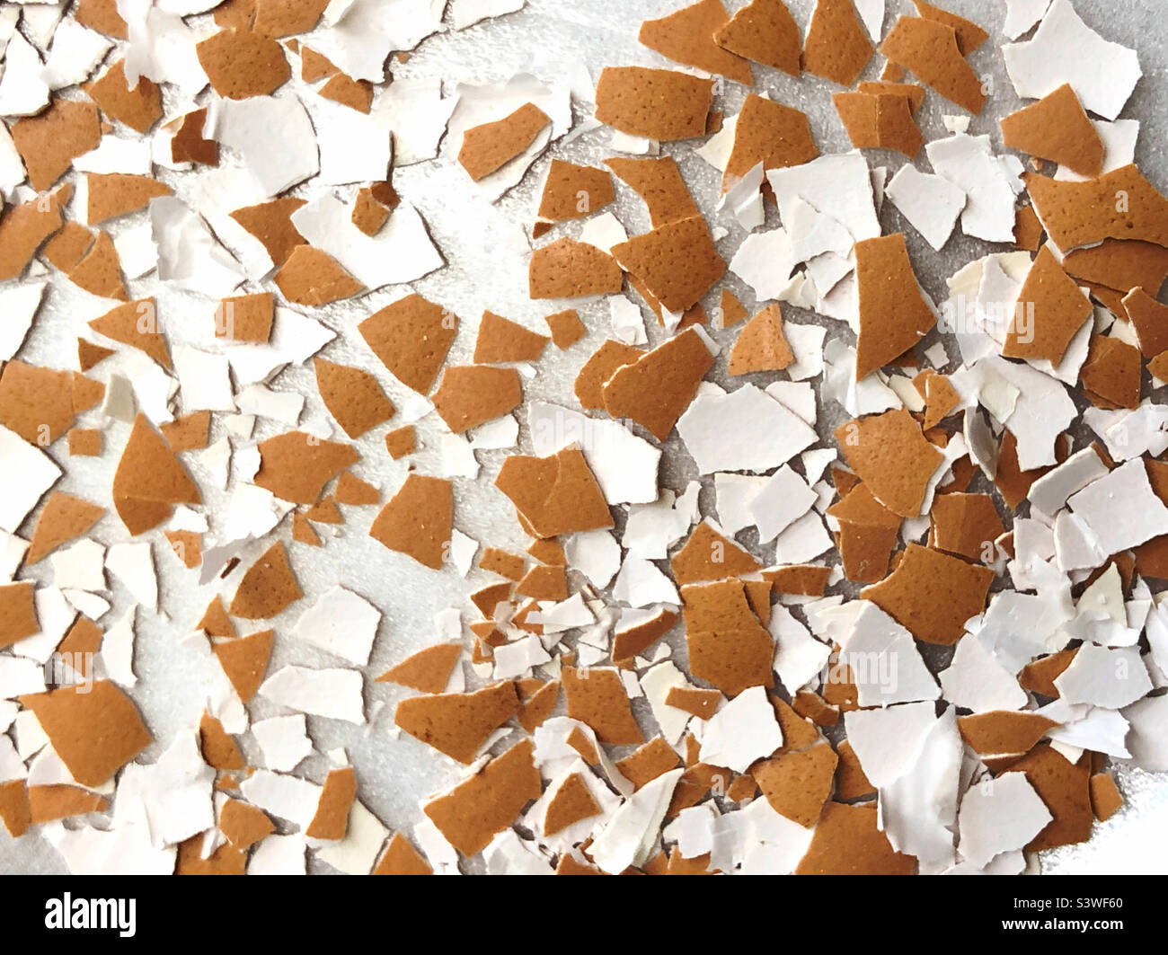 A background of crushed brown eggshells Stock Photo
