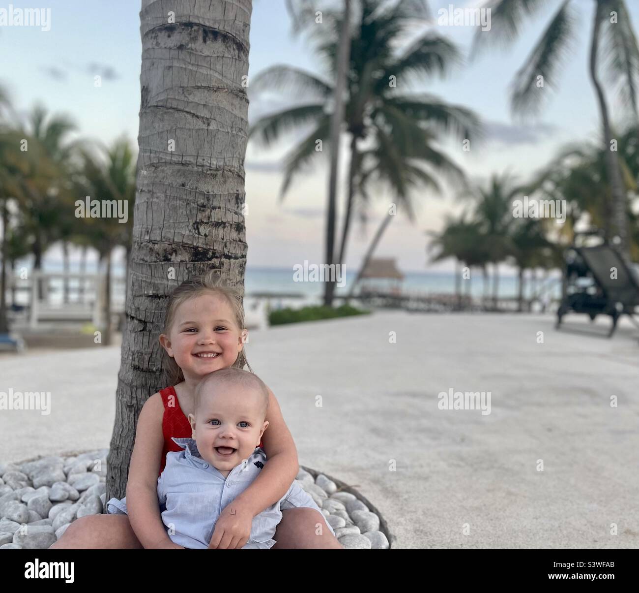 Kids on the beach at sunset Stock Photo - Alamy