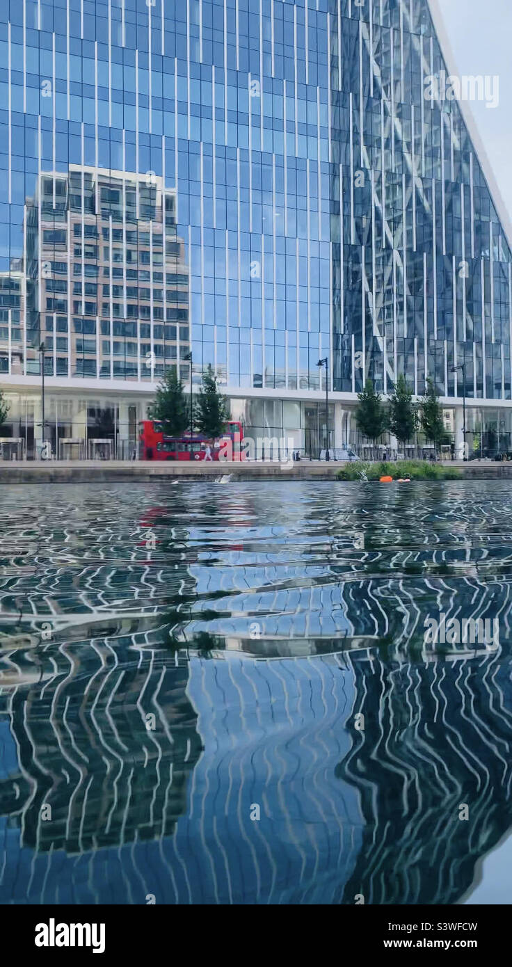 Reflection of one bank street Canary Wharf from middle dock Stock Photo