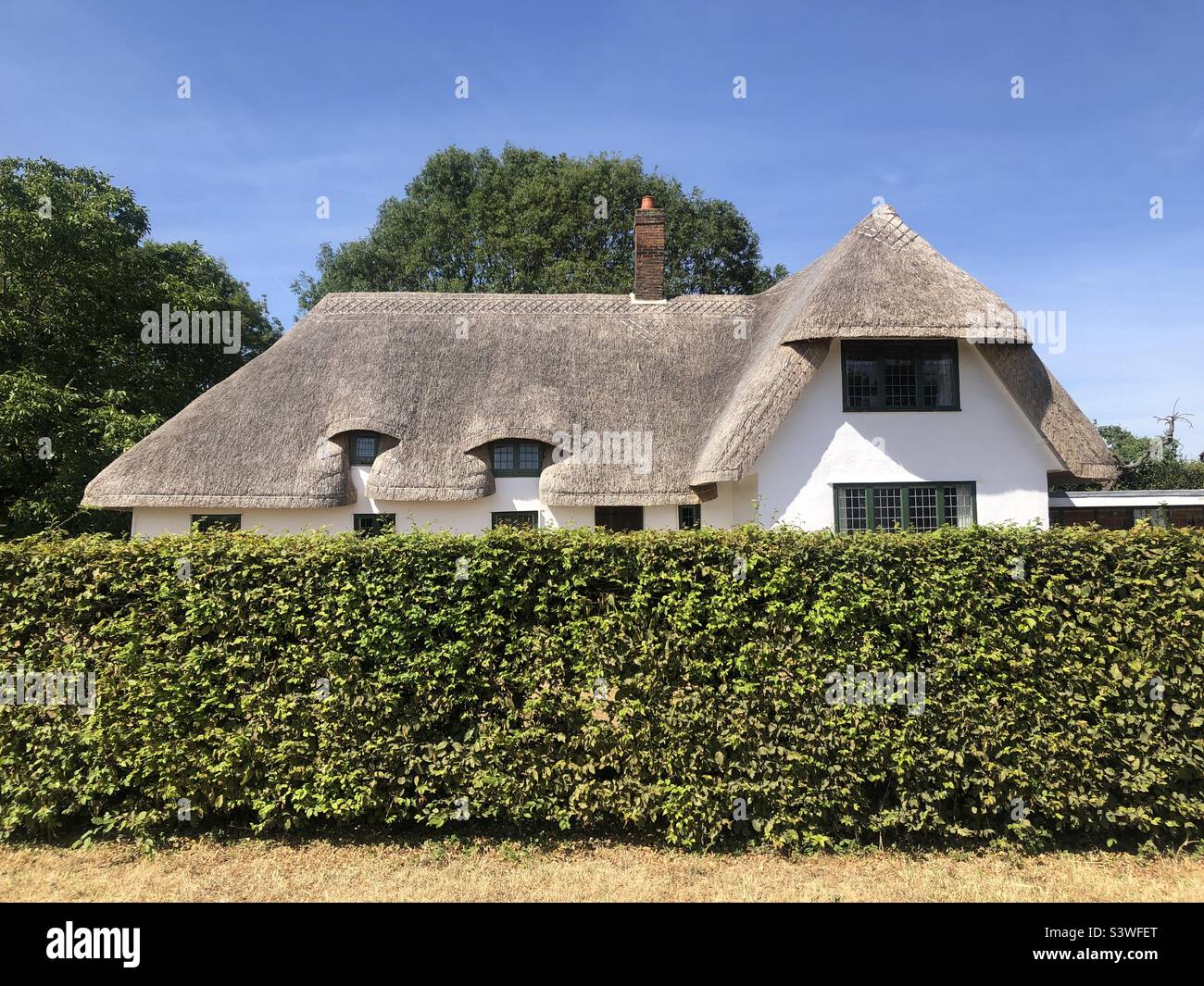 A thatched roof cottage in the English countryside - Smartphone Captured Stock Image