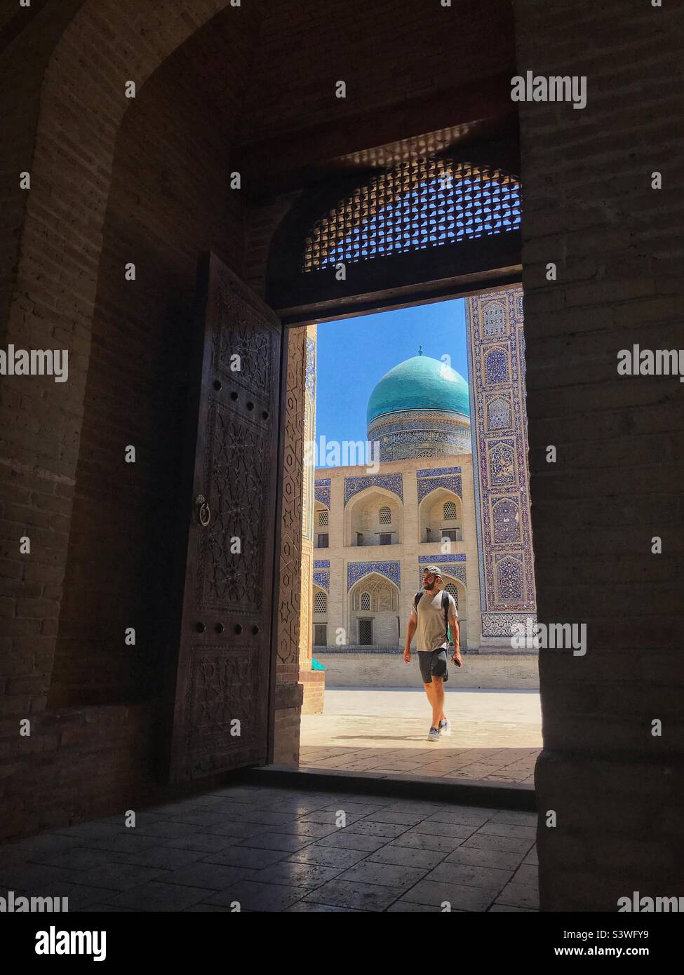 Bukhara Uzbekistan tourist visiting the historic Kalan mosque in August 2022 - Smartphone Captured Stock Image