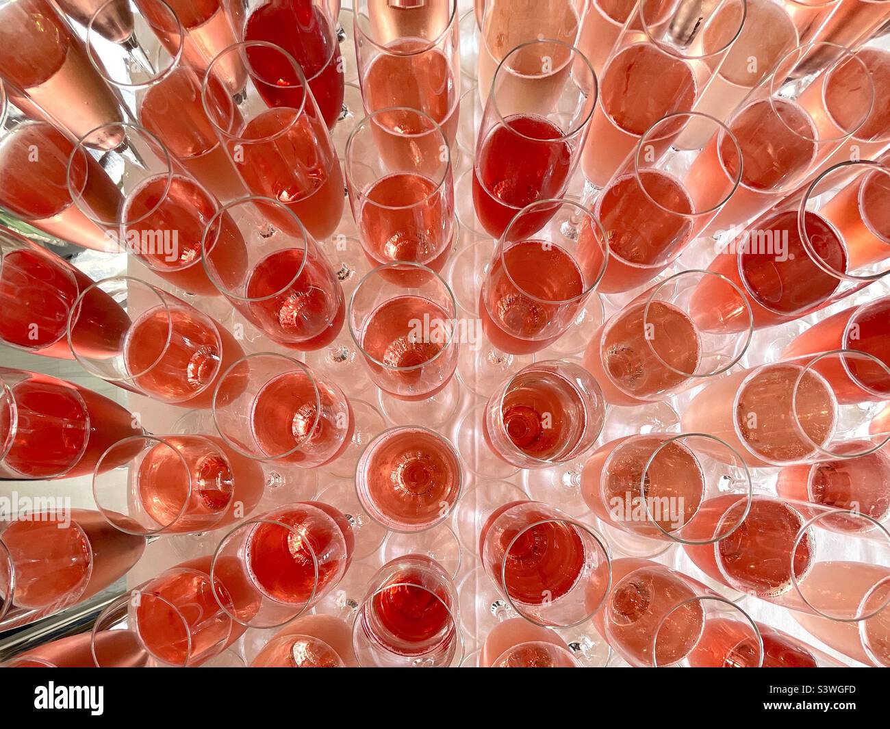 Close up view from above of champagne flute glasses with rose wine Stock Photo