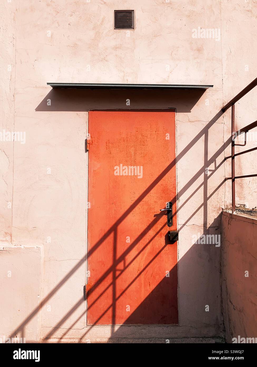 Orange door with shadows on it Stock Photo Alamy