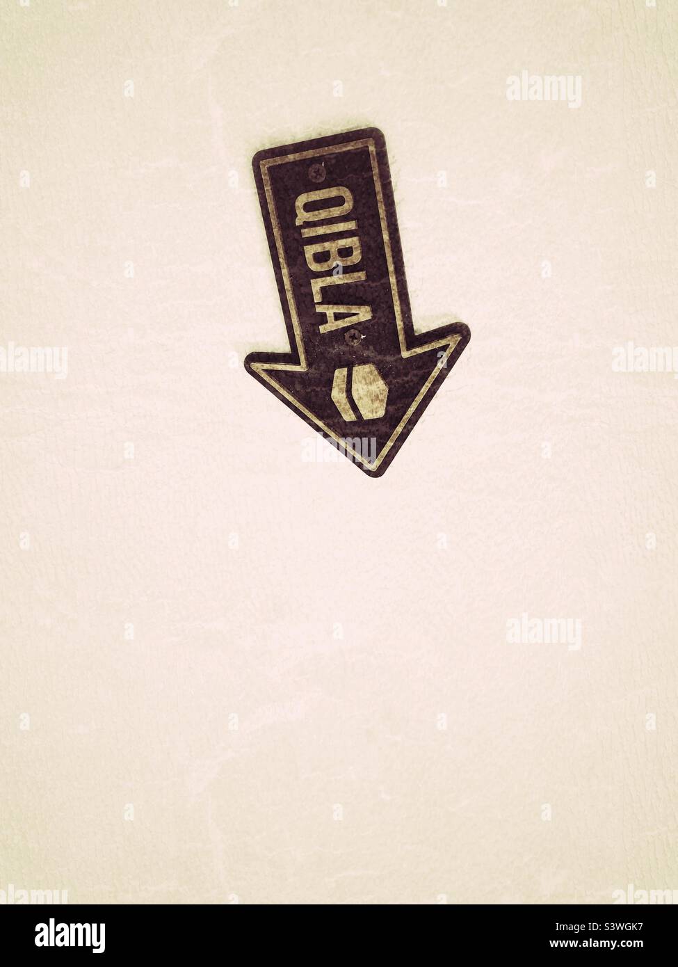 Islam Qibla sign on ceiling of hotel in Uzbekistan to help Muslim worshippers locate Mecca at prayer time - Smartphone Captured Stock Image