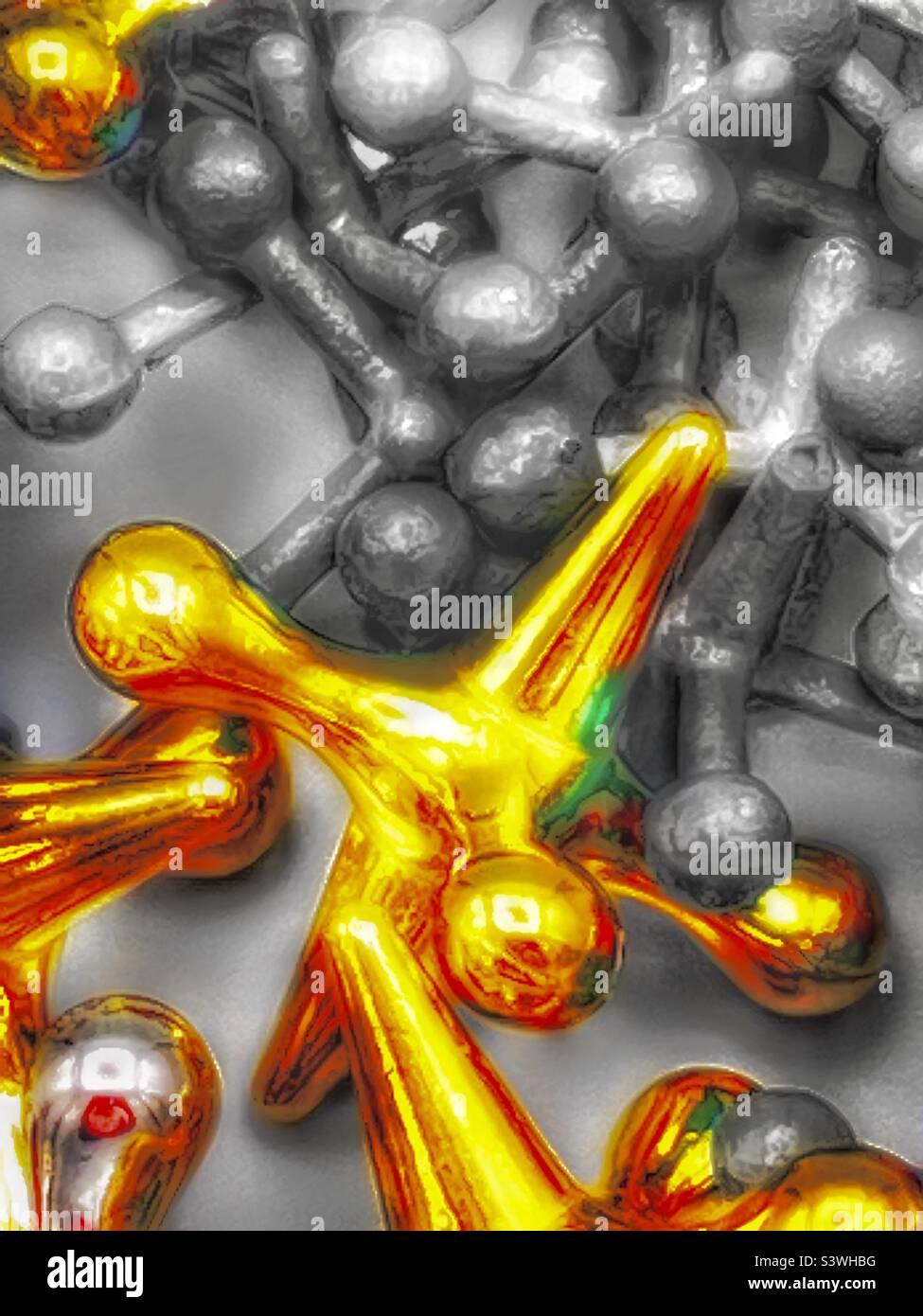 An abstract using jacks of varying sizes, textures and colors. The jumbo, or larger jacks of silver and gold, are colored and contrast with the smaller jacks that are desaturated. Stock Photo