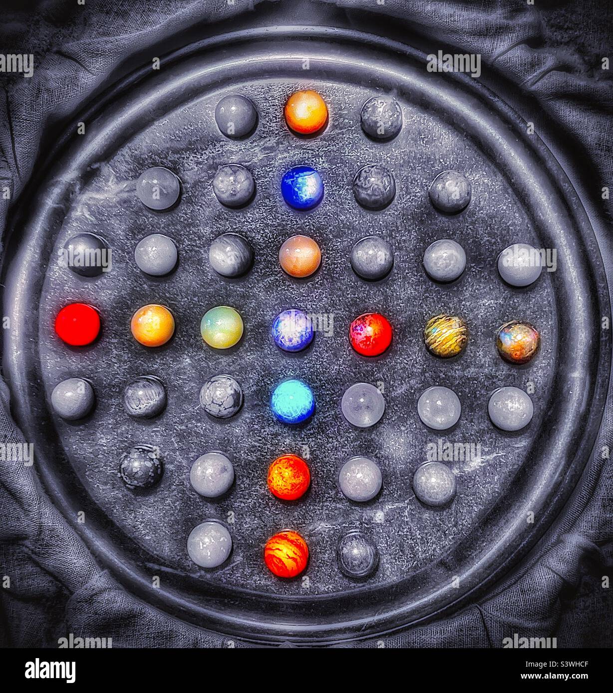 A beautiful onyx, stone marble Chinese Checker game set. Gorgeous textures and tones can be seen in the black and white image, highlighted by the patterned color select marble pieces. - Smartphone Captured Stock Image