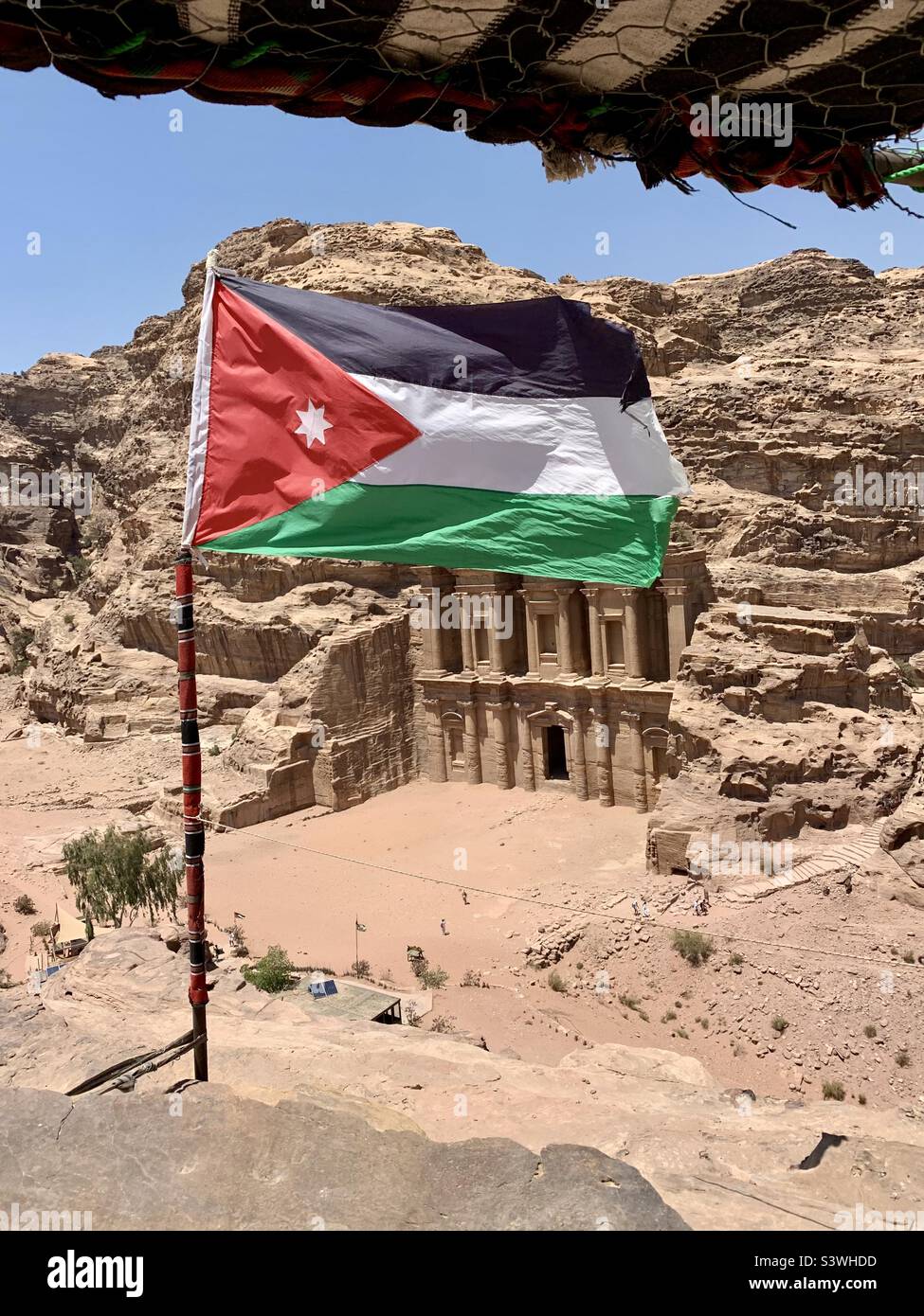Jordanian flag flying over Monastery in Petra, Jordan Stock Photo Alamy
