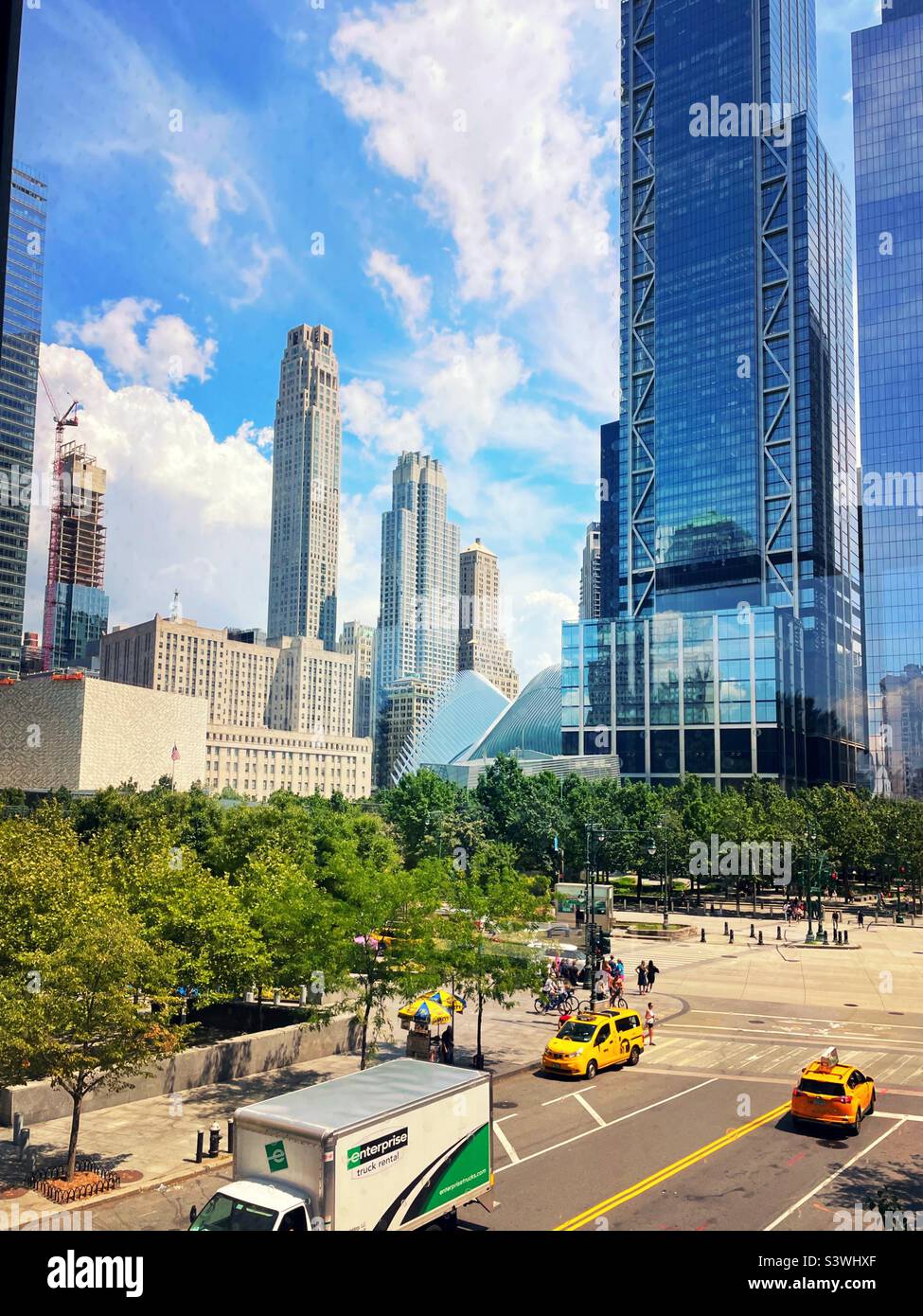 The 911 Memorial is surrounded by tall skyscrapers in the financial district of Manhattan, 2022, New York City, United States - Smartphone Captured Stock Image
