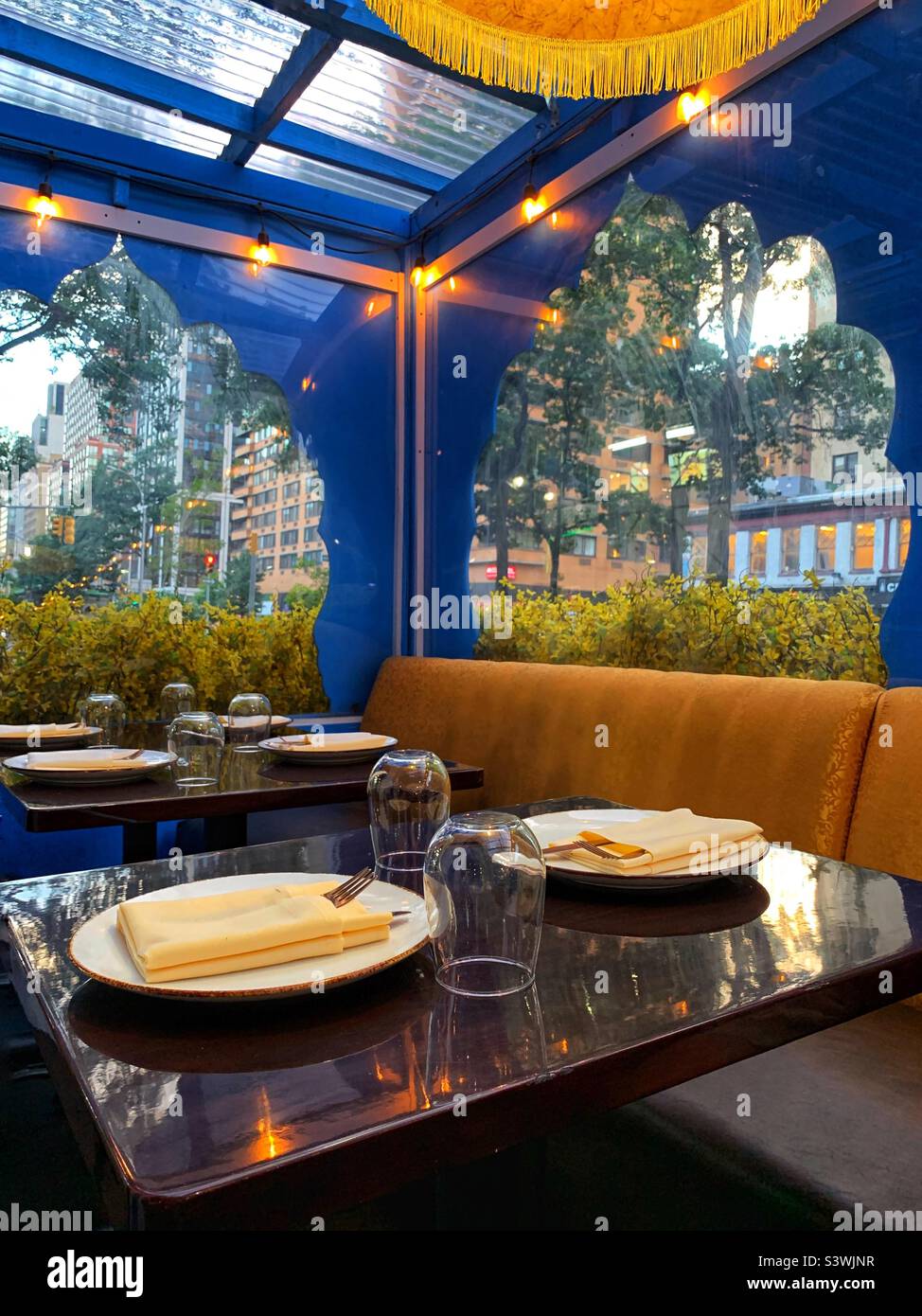 Glass, plates, table napkins on the table - Smartphone Captured Stock Image