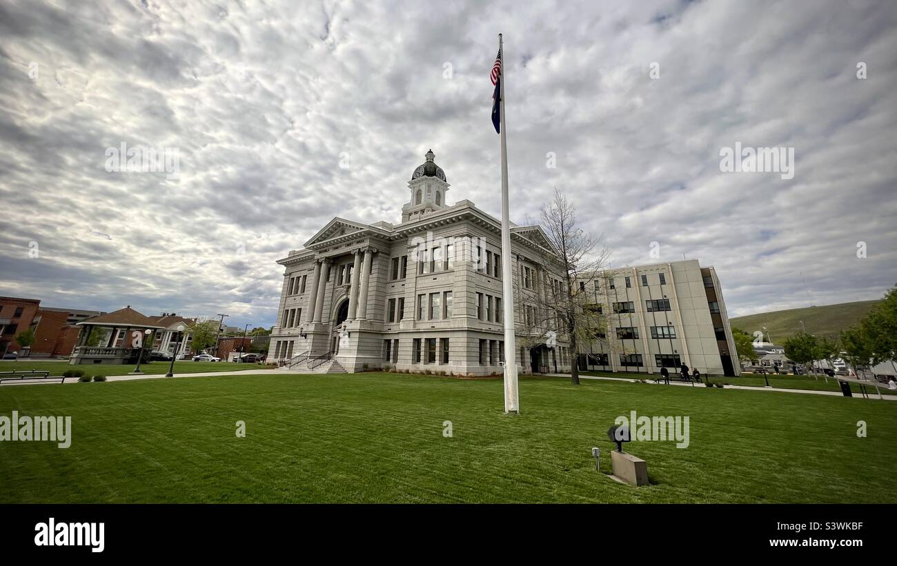 MISSOULA, MT, MAY 2022: wide angle, front view of Missoula County Courthouse, with United States flag flying, in Heart of Missoula area of downtown - Smartphone Captured Stock Image MISSOULA, MT, MAY 2022: wide angle, front view of Missoula County Courthouse, with United States flag flying, in Heart of Missoula area of downtown - Smartphone Captured Stock Image