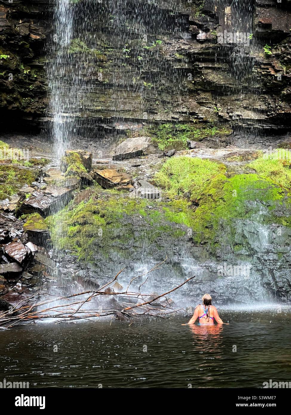 Wild swimming under a Welsh waterfall-Henrhyd fall at Coelbren, Brecon Beacons. - Smartphone Captured Stock Image