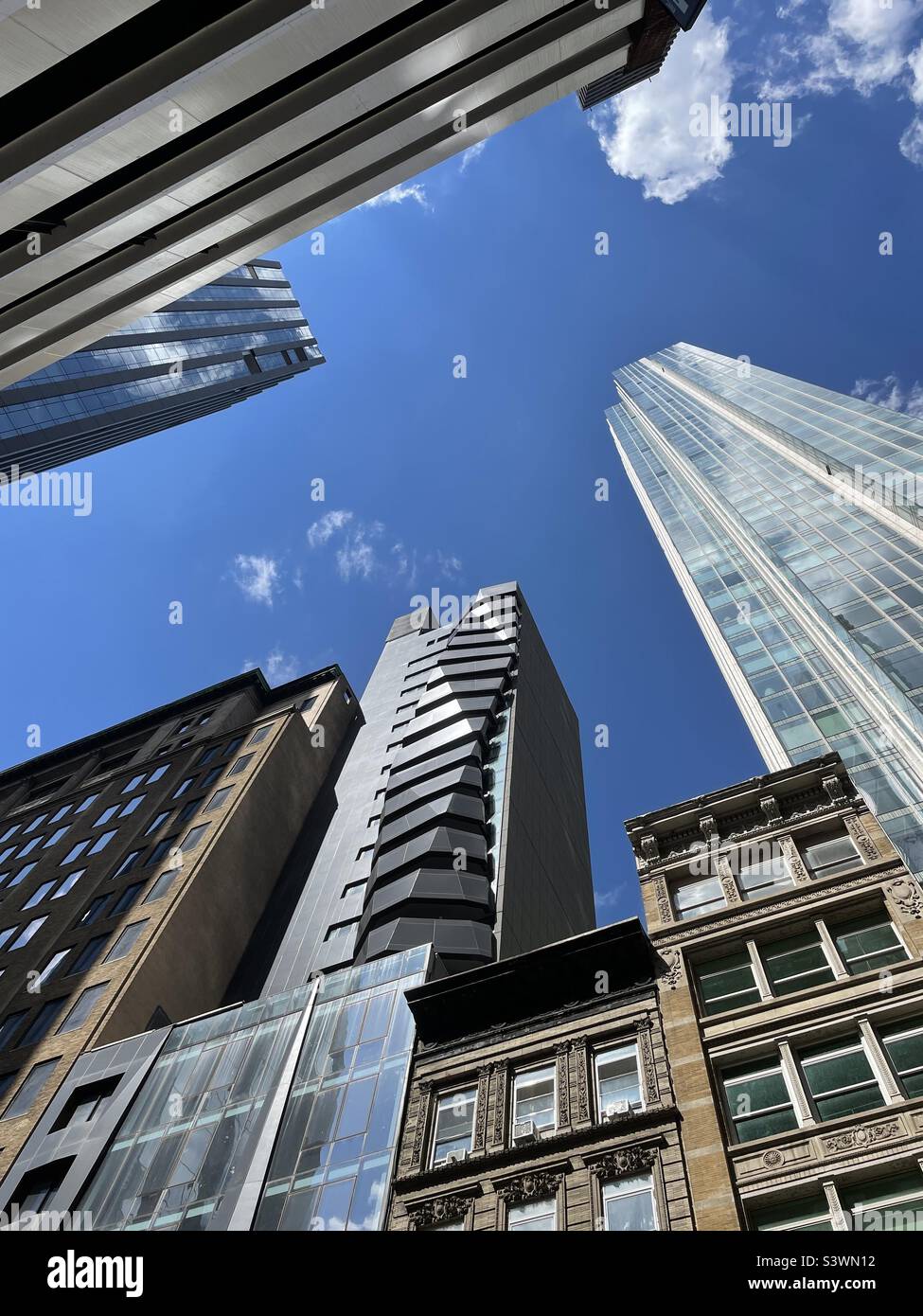 High-rise condominiums and low rise brownstones in the nomad area of New York along E. 30th St., 2022, New York City, USA - Smartphone Captured Stock Image