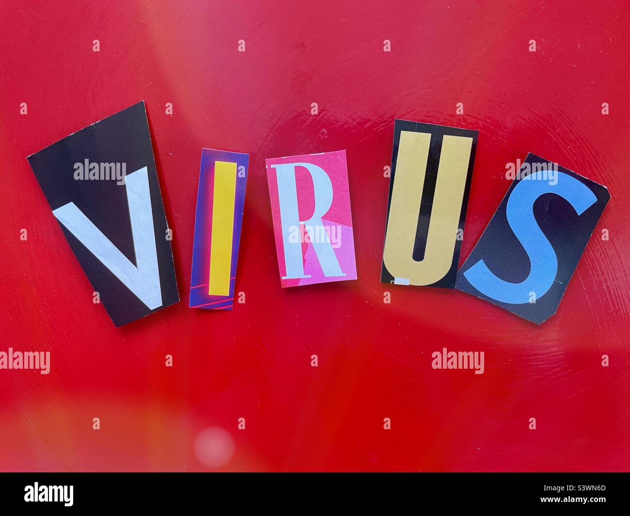 Virus spelled out in Ransom noteStyle topography on A red background, 2022, USA - Smartphone Captured Stock Image
