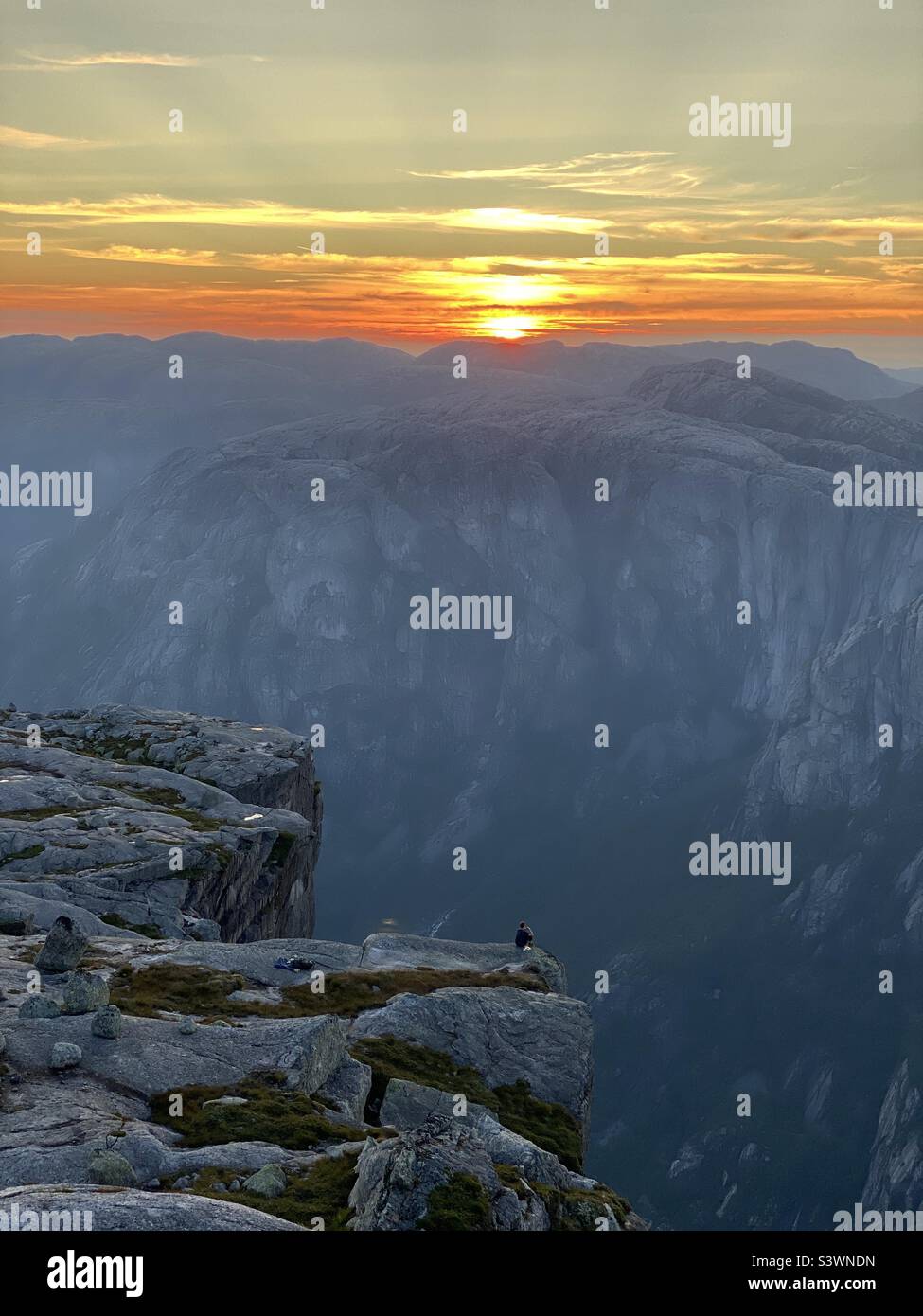 A beautiful sunset at Kjerag boulder, Norway - Smartphone Captured Stock Image