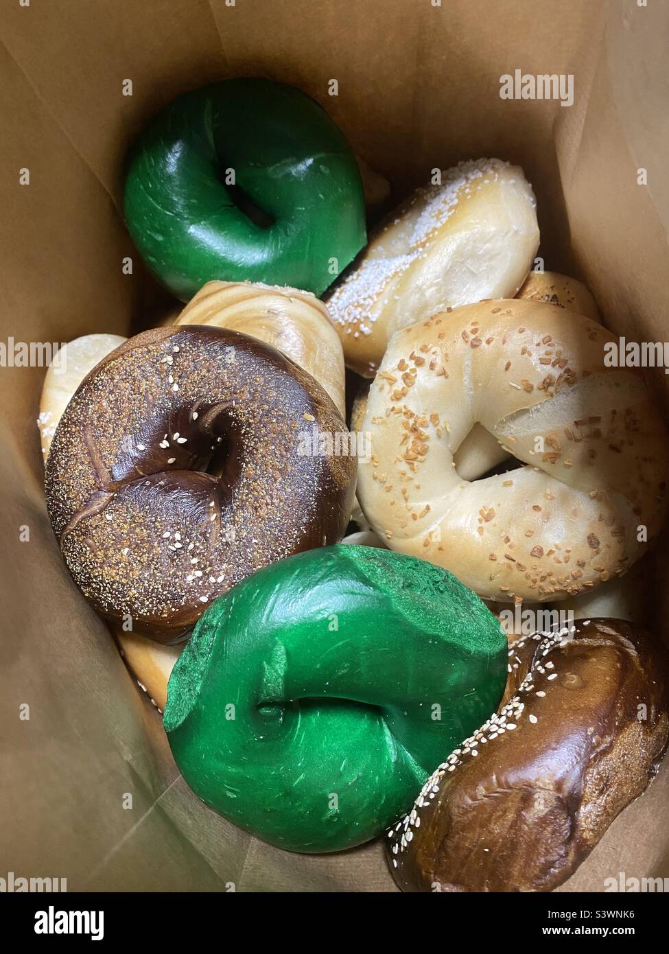 Bag of bagels, some are green Stock Photo Alamy
