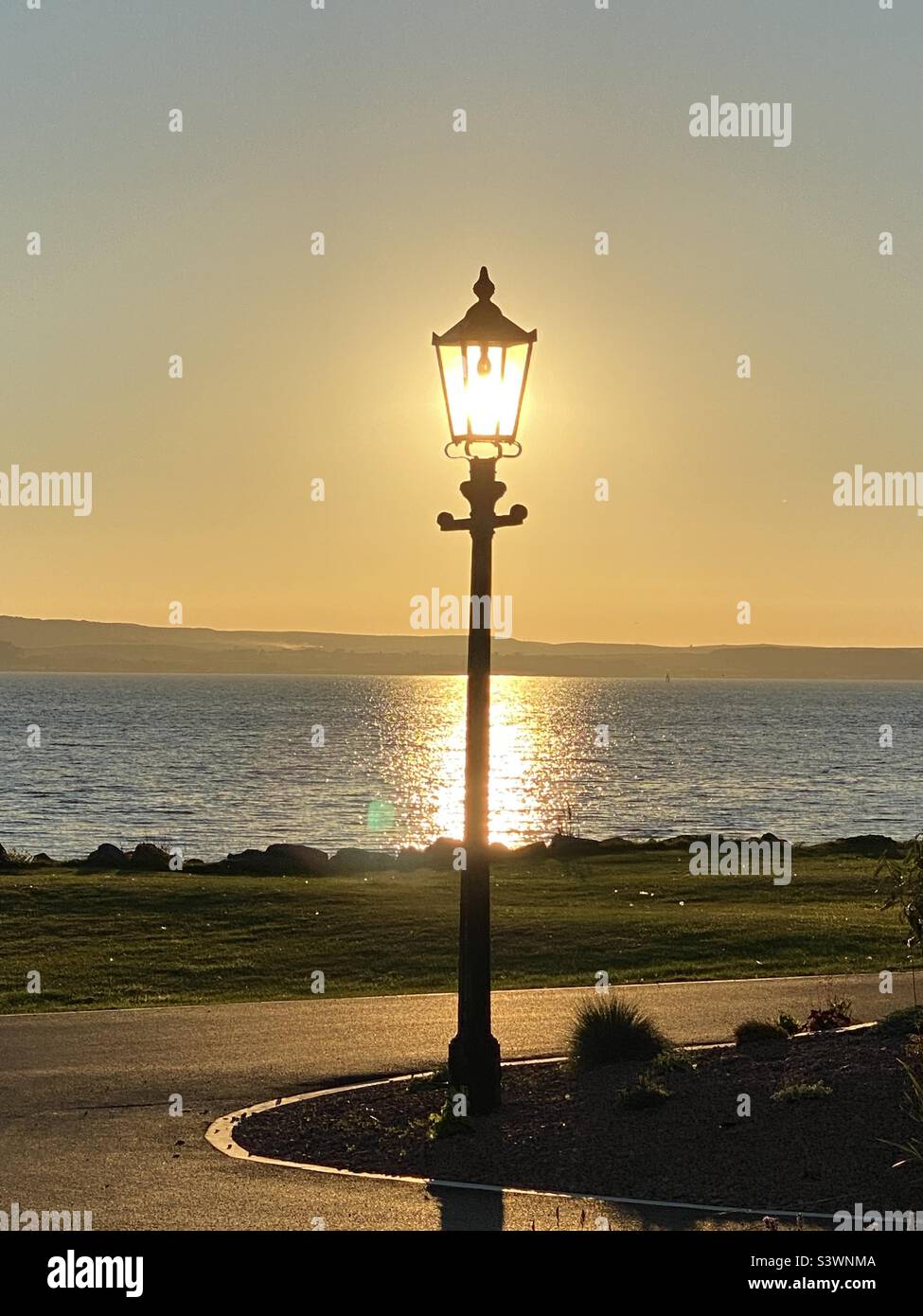 Sunset captured in an an ornate lantern lamp post in Stranraer, West Scotland Stock Photo