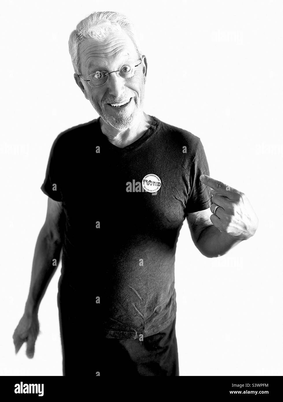 American male exercising the right to vote, wearing a sticker 'I VOTED.' - Smartphone Captured Stock Image