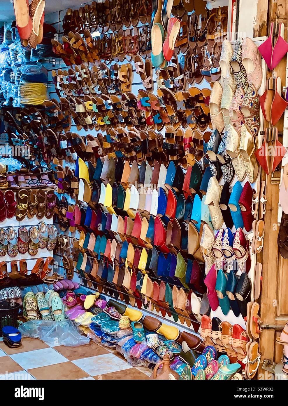 Colourful Moroccan babouches, traditional leather slippers on sale in the Souks in Marrakesh medina, Morocco, North Africa. Stock Photo