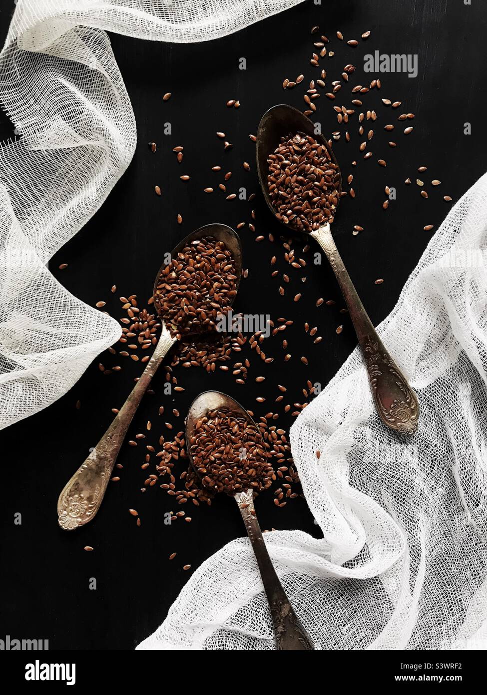 Flax seeds in three rustic spoons - Smartphone Captured Stock Image