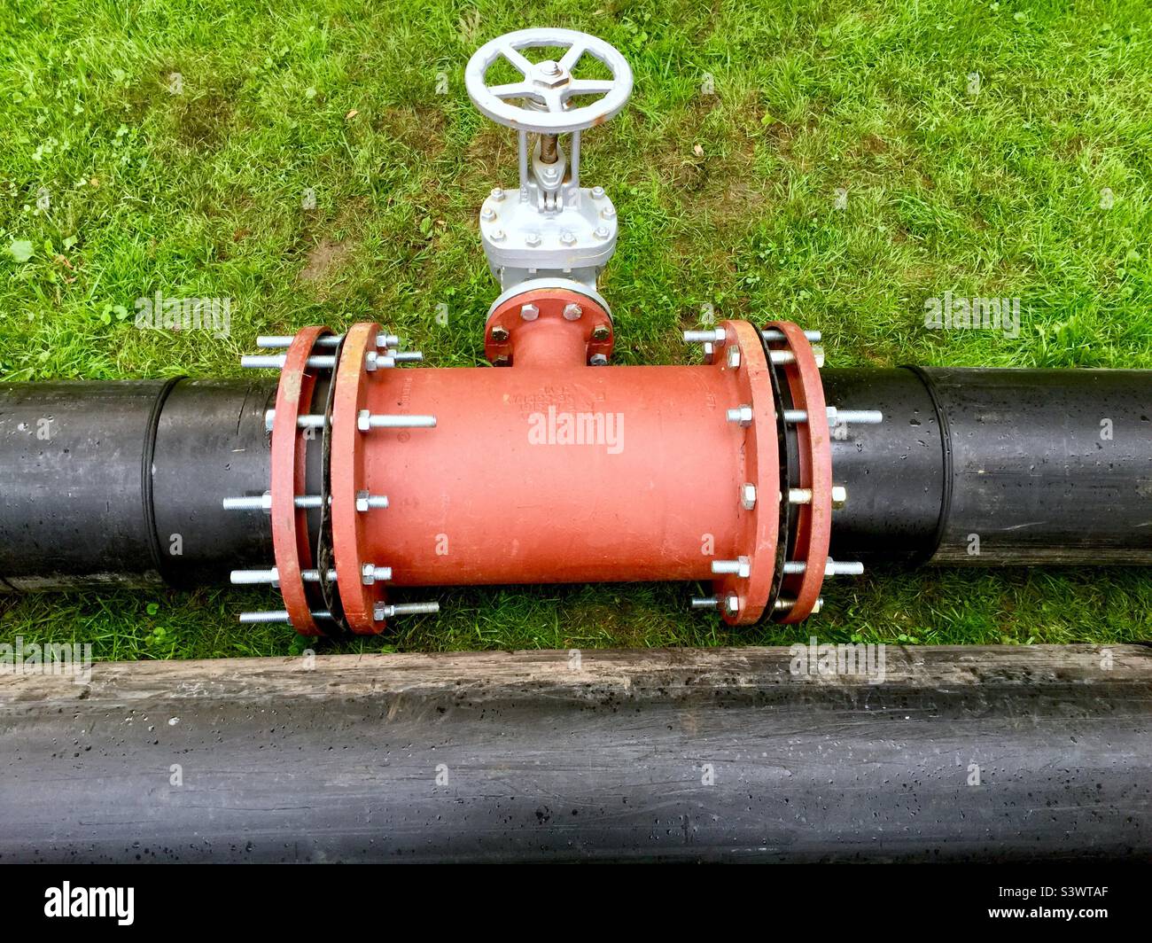 Pipes joined and valve, outdoors. Ontario,  Canada. Temporary drainage project. Stock Photo