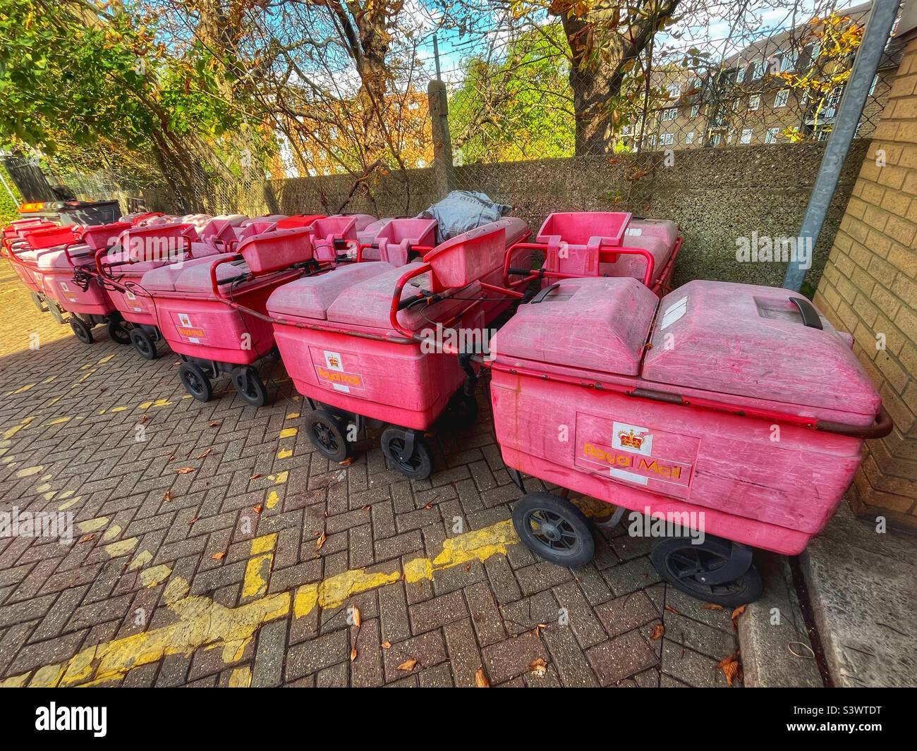 Posties barrows on strike, all in a line outside a Royal Mail depot in Forest Hill, London - Smartphone Captured Stock Image