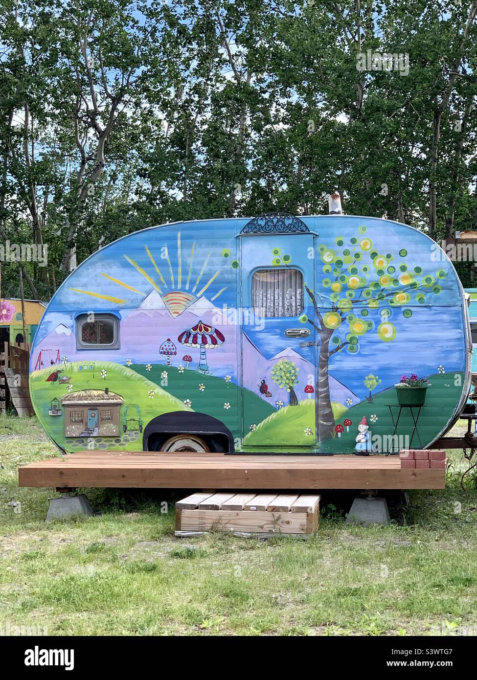 Camper painted with a mural and converted to a Bed and Breakfast in