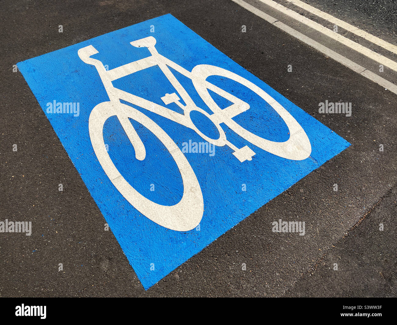 A blue and white graphic sign indicating this area is a cycle lane. Photo ©️ COLIN HOSKINS. Stock Photo