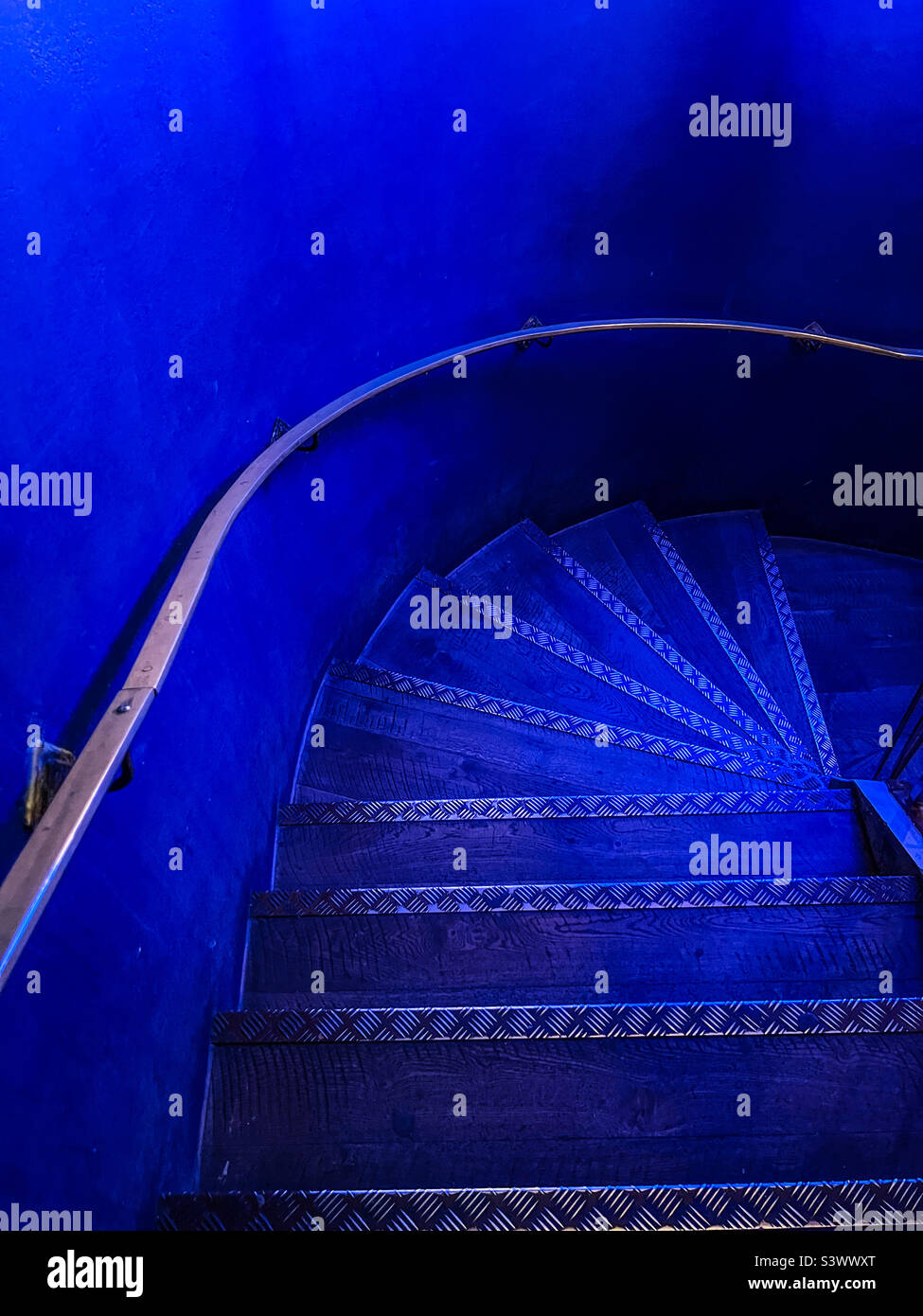 Wooden steps and staircase in blue light - Smartphone Captured Stock Image
