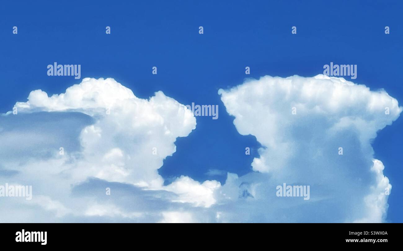 Building cumulonimbus clouds billowing above the Wasatch Mountain Range in Utah, USA bordering Salt Lake City on the east, on a hot summer day. Stock Photo